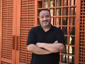 A man standing and smiling