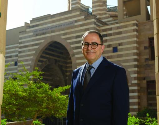 AUC President Ahmad Dallal standing in front of Portal