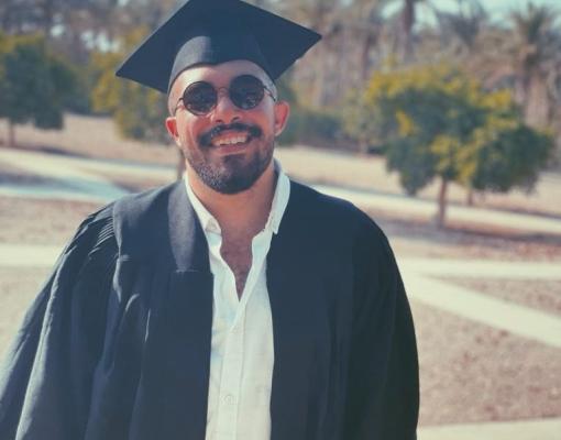 Smiling boy with cap and gown