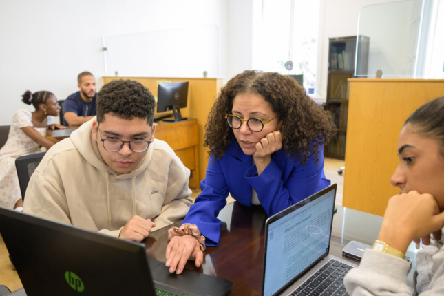 Dr. Rabab helping students at APS