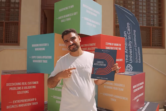 A person in front of a pyramid of cubes with text on their sides, points to a folder that says career accelerator