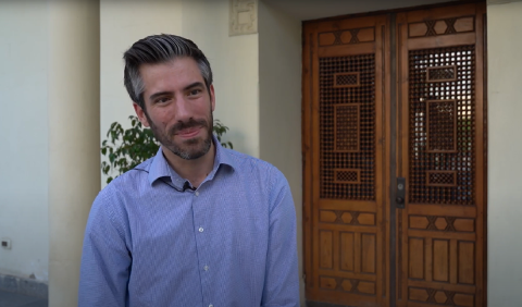 A man standing in front of an old Arabian oriental door