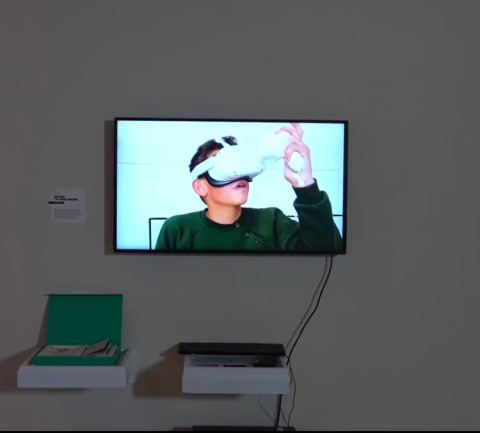 Screen displaying a boy wearing VR glasses and a keyboard under the screen