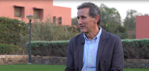 A man talking and sitting in a garden