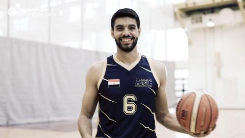 A male student athlete holding a basketball