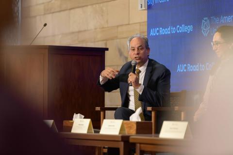 provost speaking through the microphone to an audience