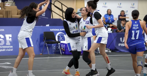 Female students playing basketball