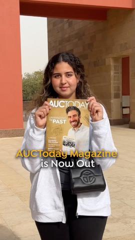 A girl is holding AUCToday magazine