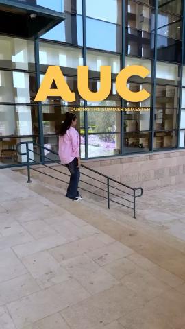 A female is going down the stairs. Text: AUC during the summer semester