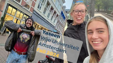 A male and two females are smilng. The male is showing his t-shirt that shows Footplayer Mohamed Salah as a pharoah. Text Yaseen, Vrije Universiteit Amsterdam Fall 2024