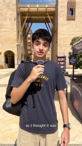 A male is talking into a microphone