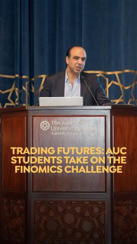 A man is standing ata podium. Text: Trading Futures: AUC Students take on the Finomics Challenge