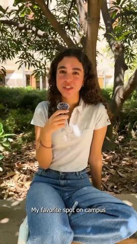 A female is sitting in a garden and talking into a microphone. Text: My Favorite Spot on Campus