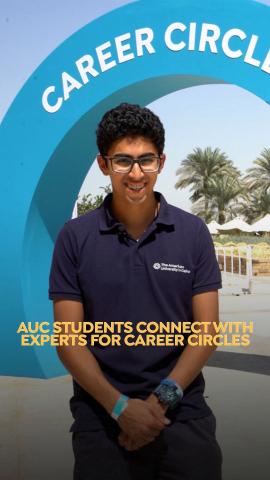 A male is standing and smiling. Text: AUC Students Connect with Expert for Career Circles