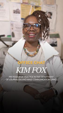 A woman is sitting and smiling. She is wearing glasses. Rext: office chat, Kim Fox, Professor of Practice of Journalism and Mass Communication