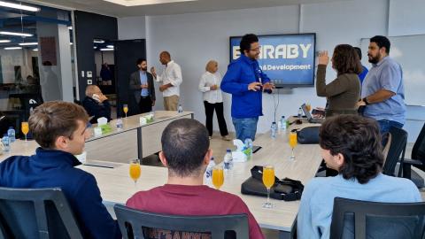 People standing and others are sitting. They are talking