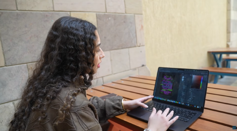A female is using a laptop