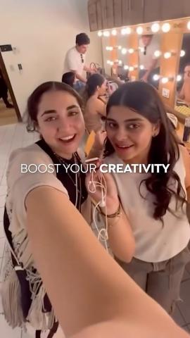 Two females are standing and smiling. Text: Boost Your Creativity