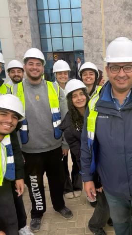 Males and females wearing protective helmets and vests. They are smiling