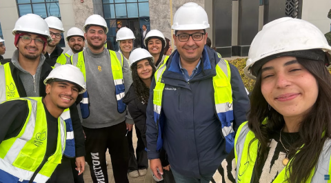 Males and females are standing and smiling