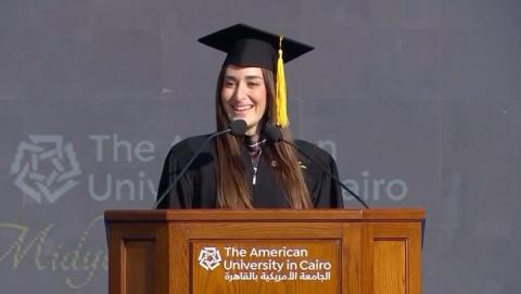 A female is standing at podium giving a speech