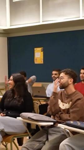Students sitting in a classroom. They are smiling