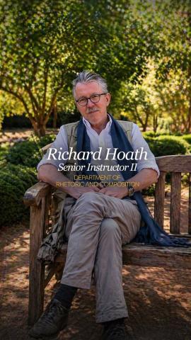 A man is sitting on a chair and smiling. He is wearing glasses