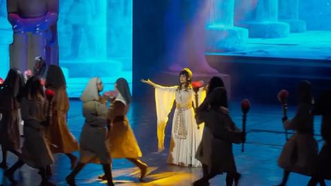 Male and female actors dressed in pharaonic costumes standing on stage
