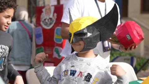 Kids playing and one of the kids is wearing a mask