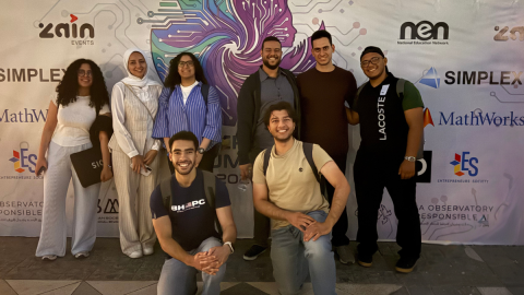 Males and females are standing and smiling