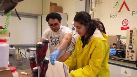 A male and a female are working in a lab