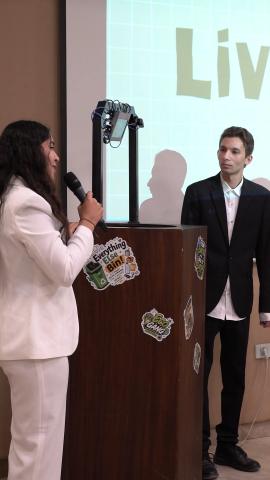 A male and a female standing at a podium