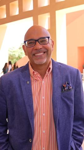 A man is standing and smiling