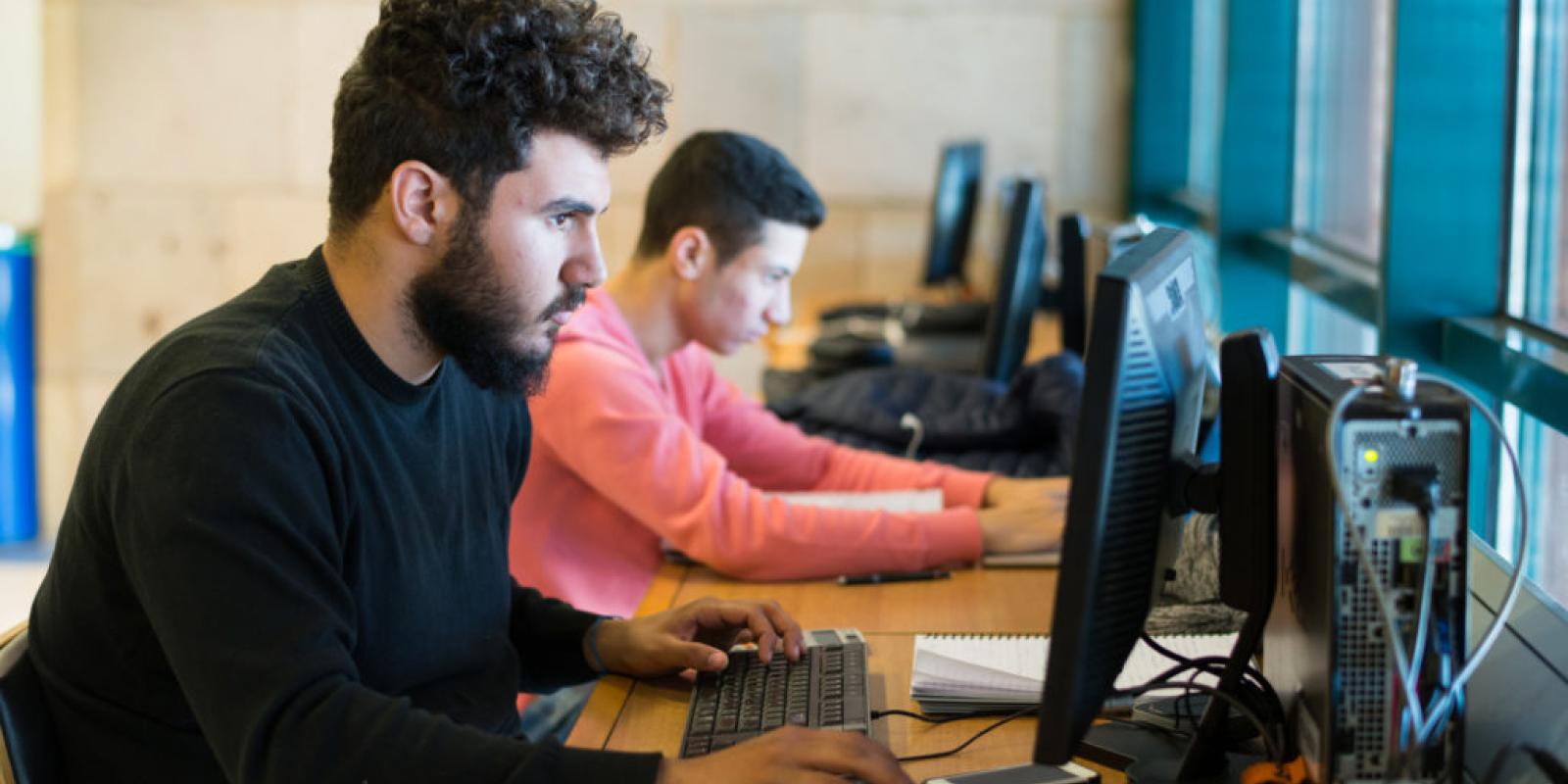 AUC students on the computers in the library 