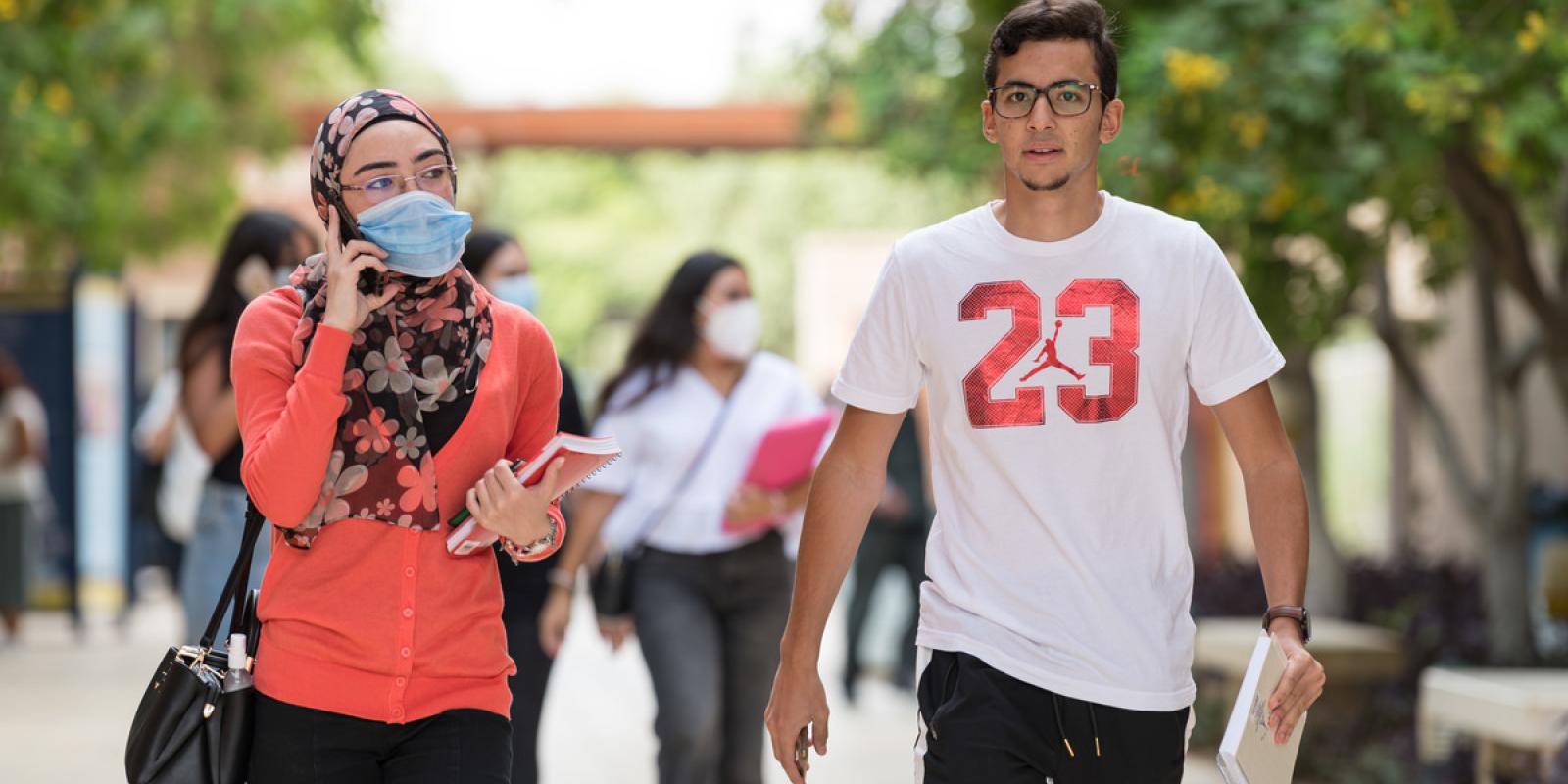 Girl and boy walking on campus