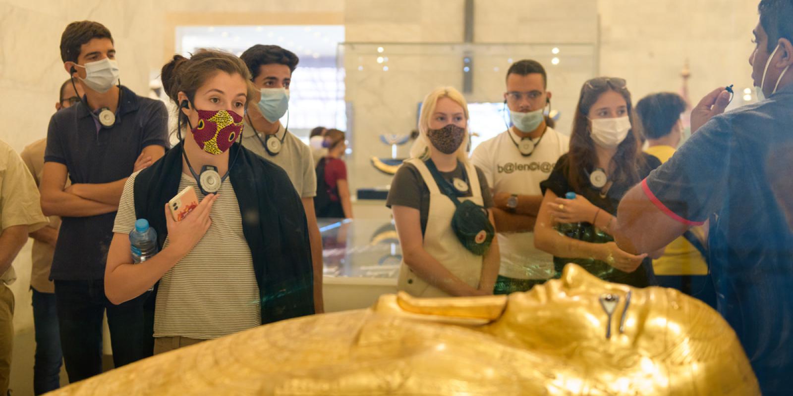 Group of students looking at a tomb at a museum