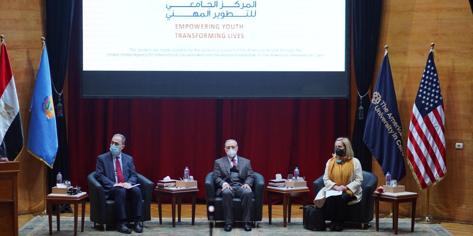 People sitting on stage at the event