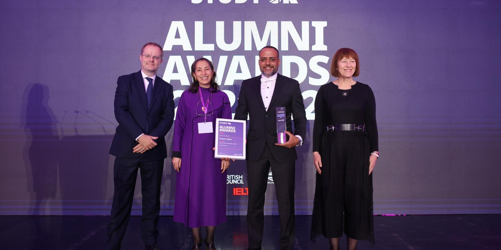 Three people giving award to a man, the Study UK Alumni Award