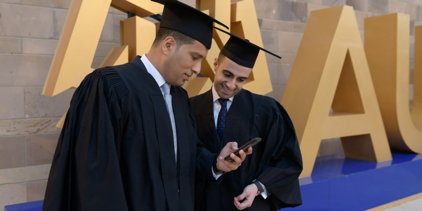 Two male graduates in their caps and gowns