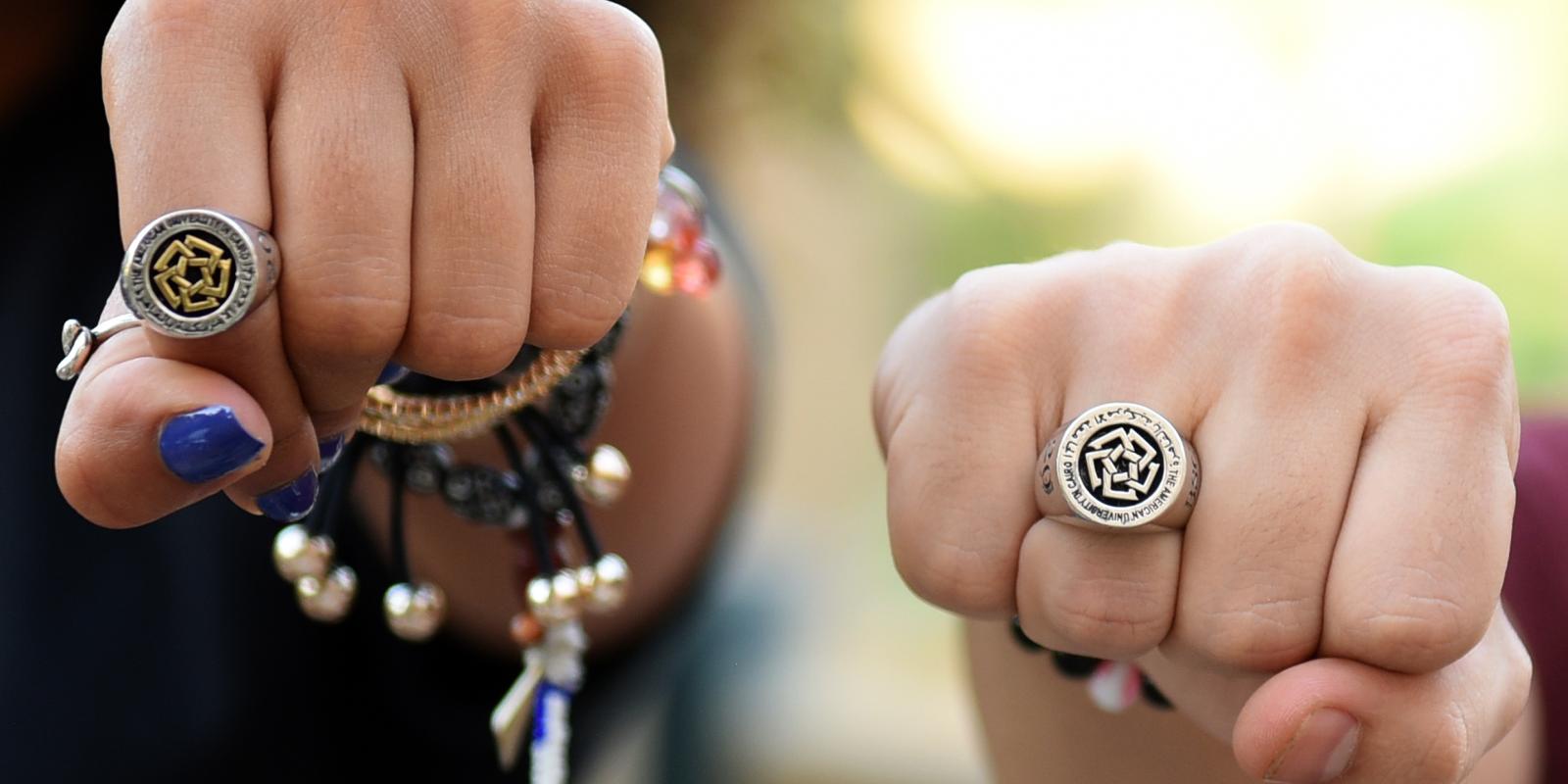Close up of class rings being worn by students