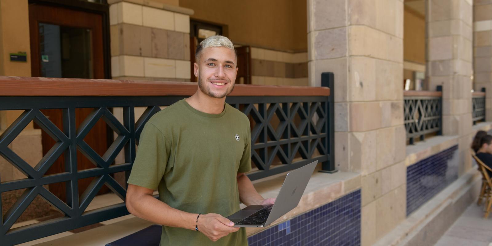 Boy holding a laptop