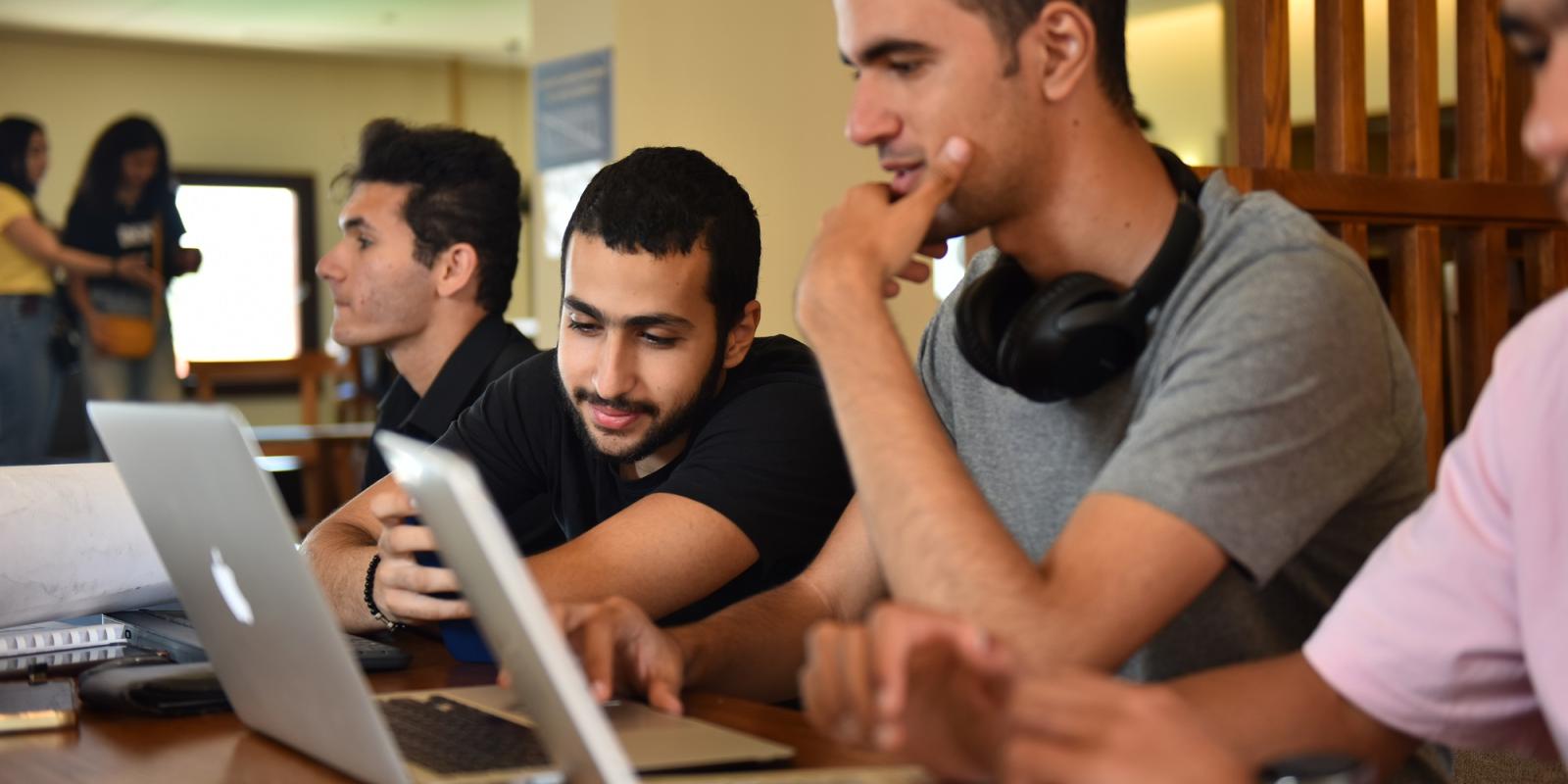 Boys sitting on laptop