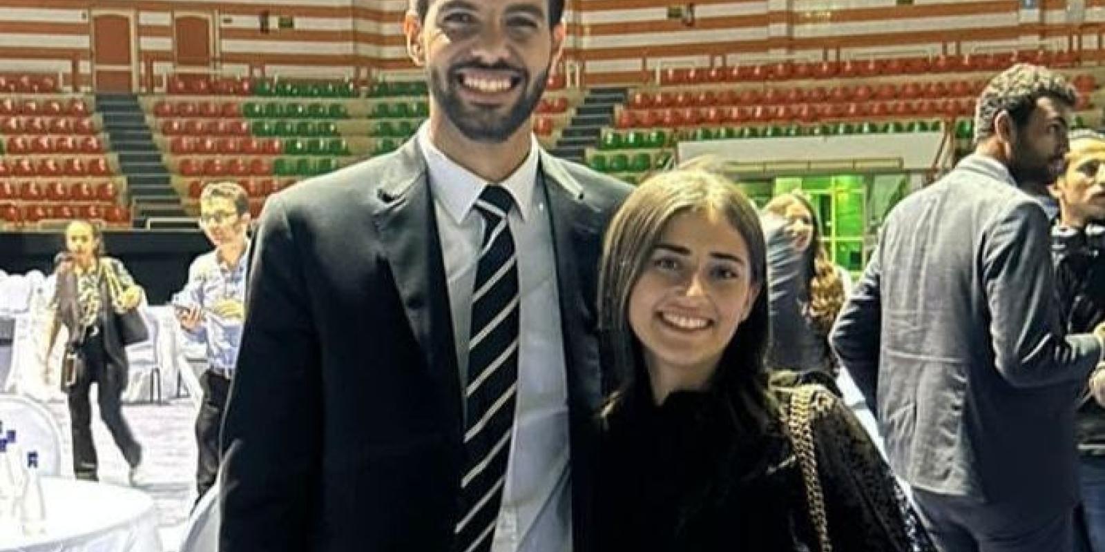 A male and female students standing and smiling