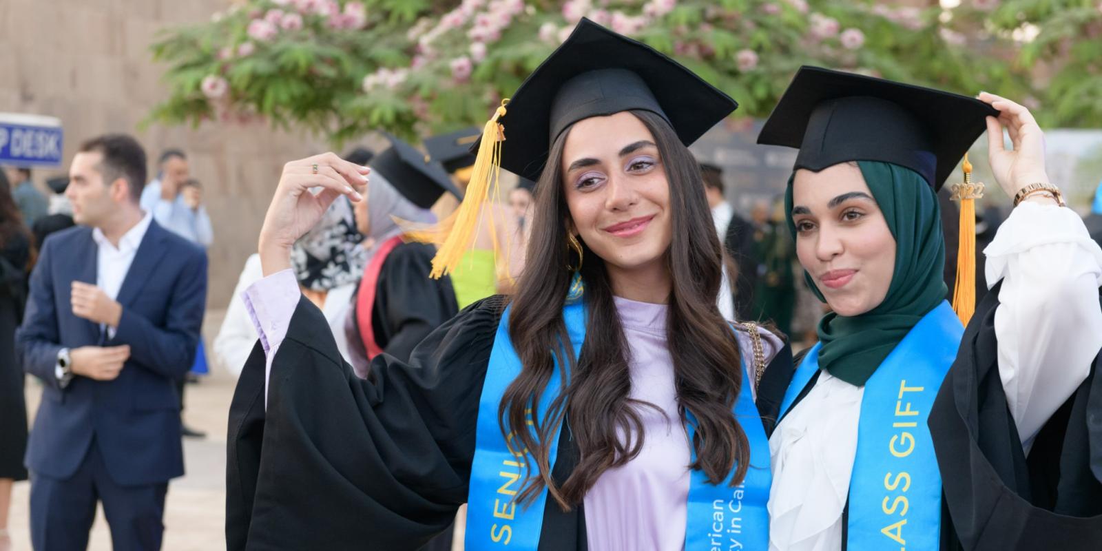 Two female graduates in their caps and gowns