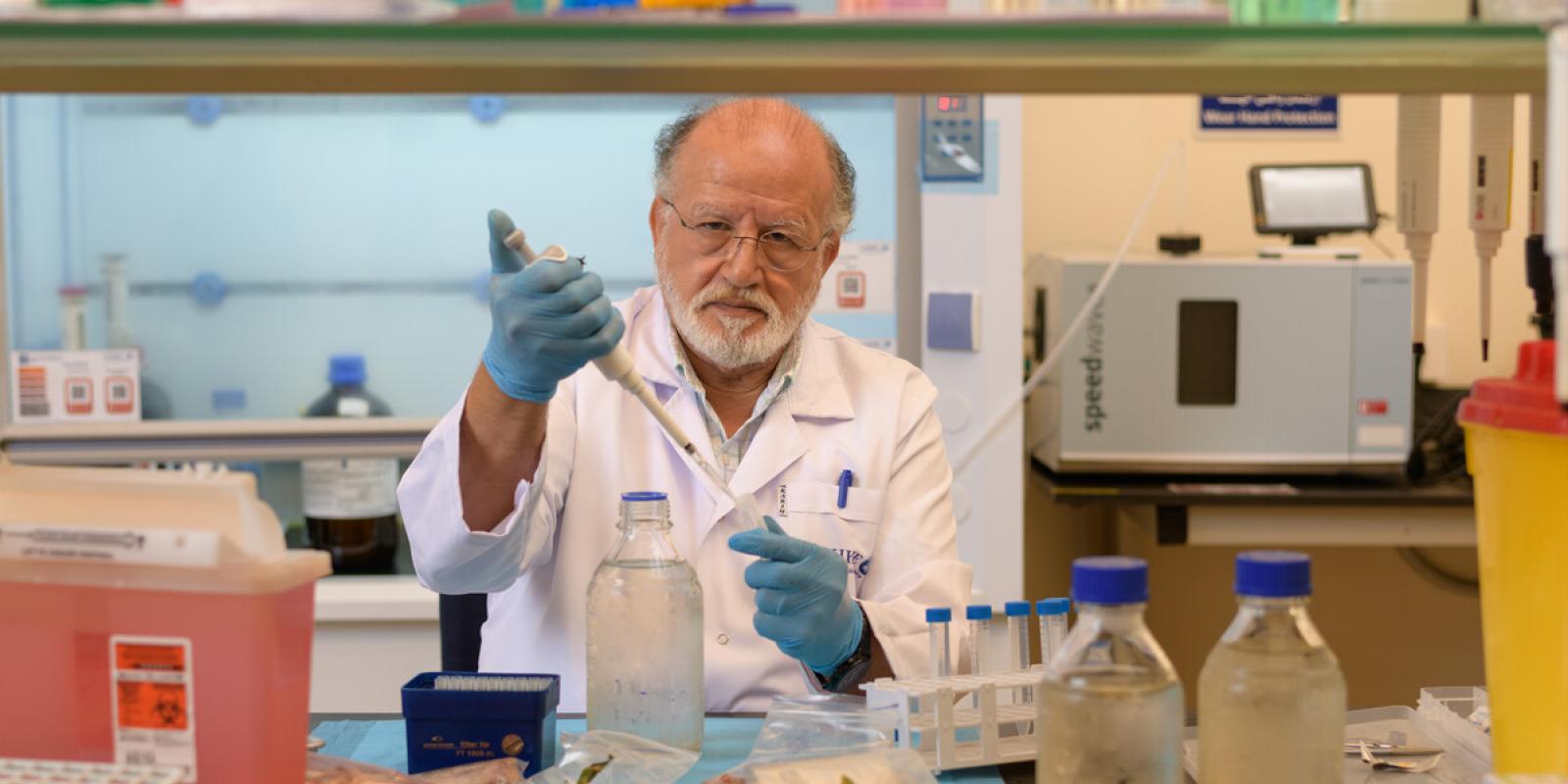 A scientist in a lab holding a test tube