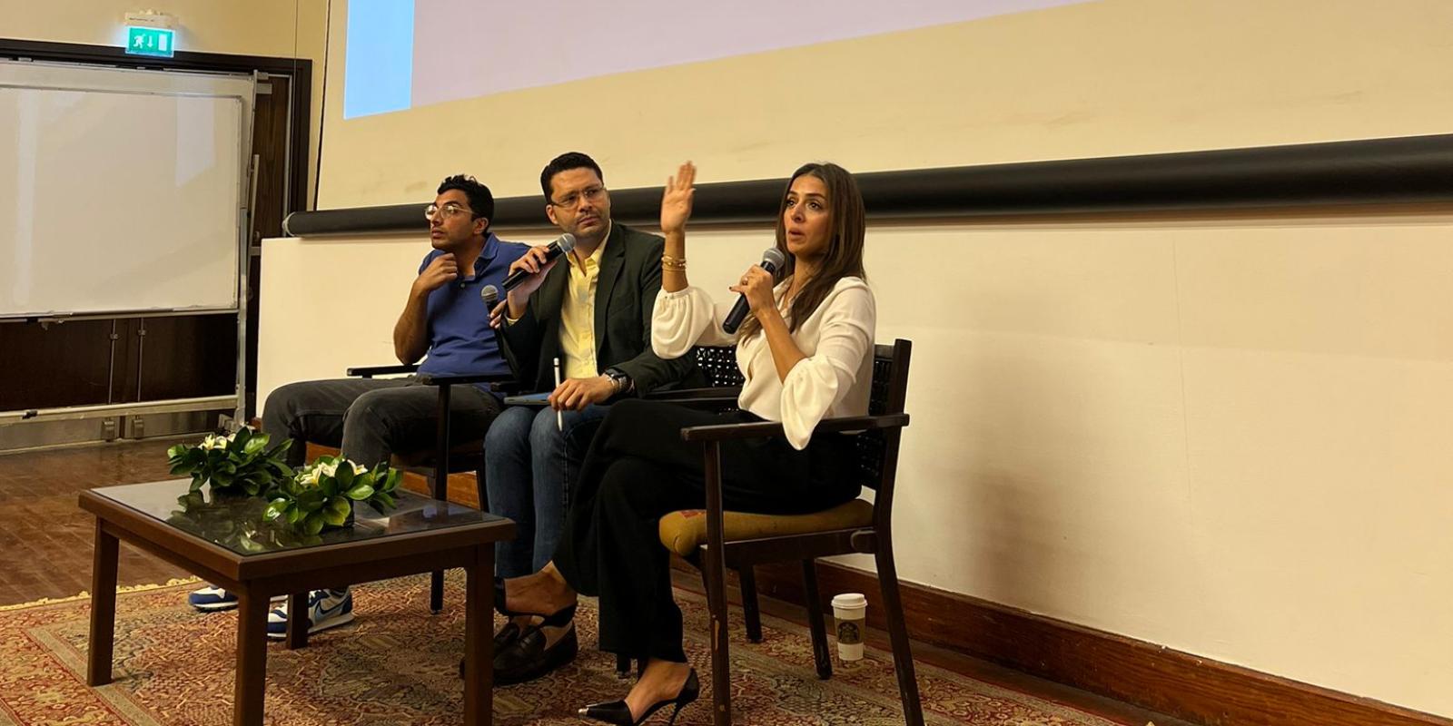 three panelists on sitting on stage