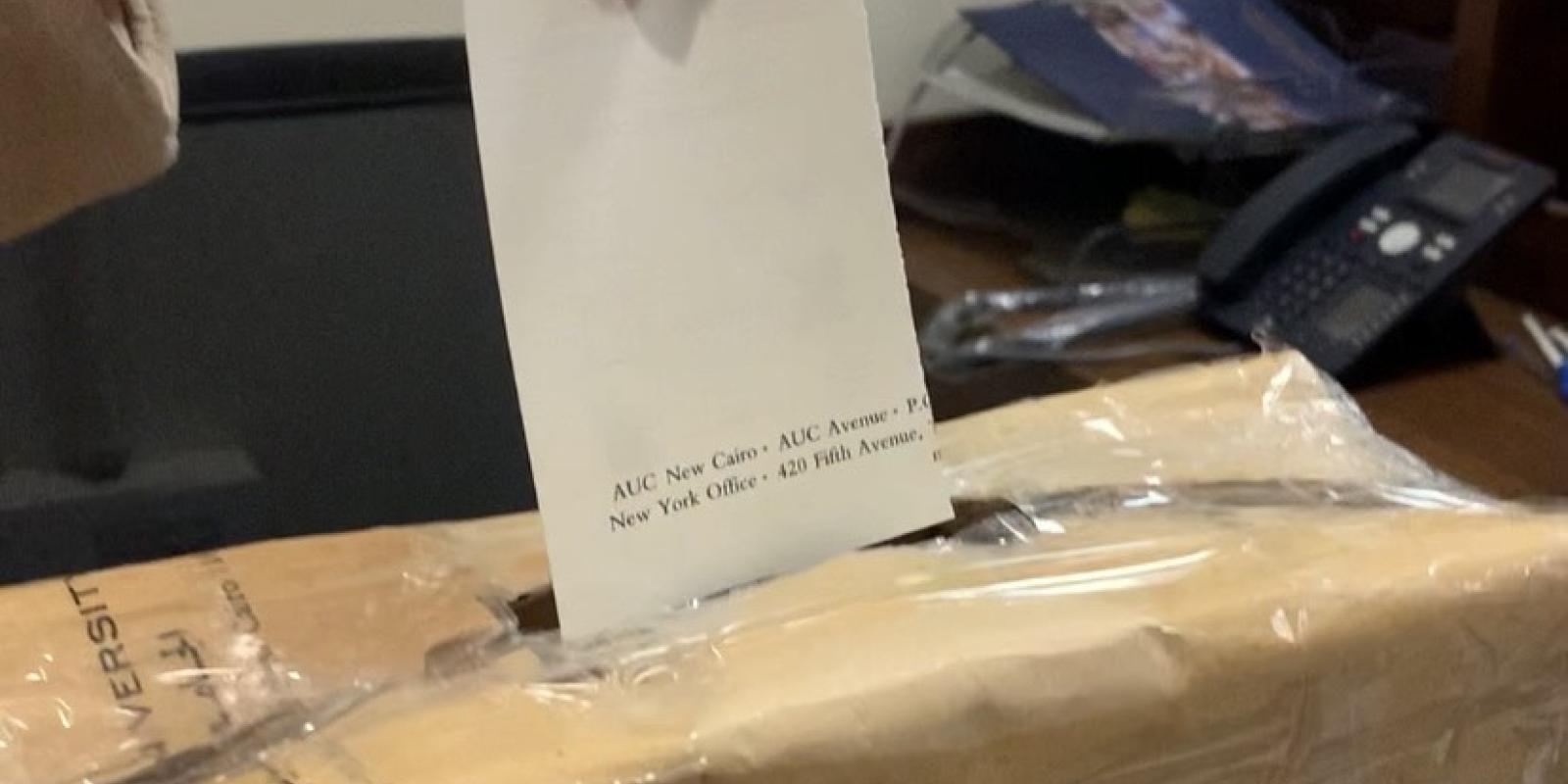 Picture of box with hand putting a paper inside