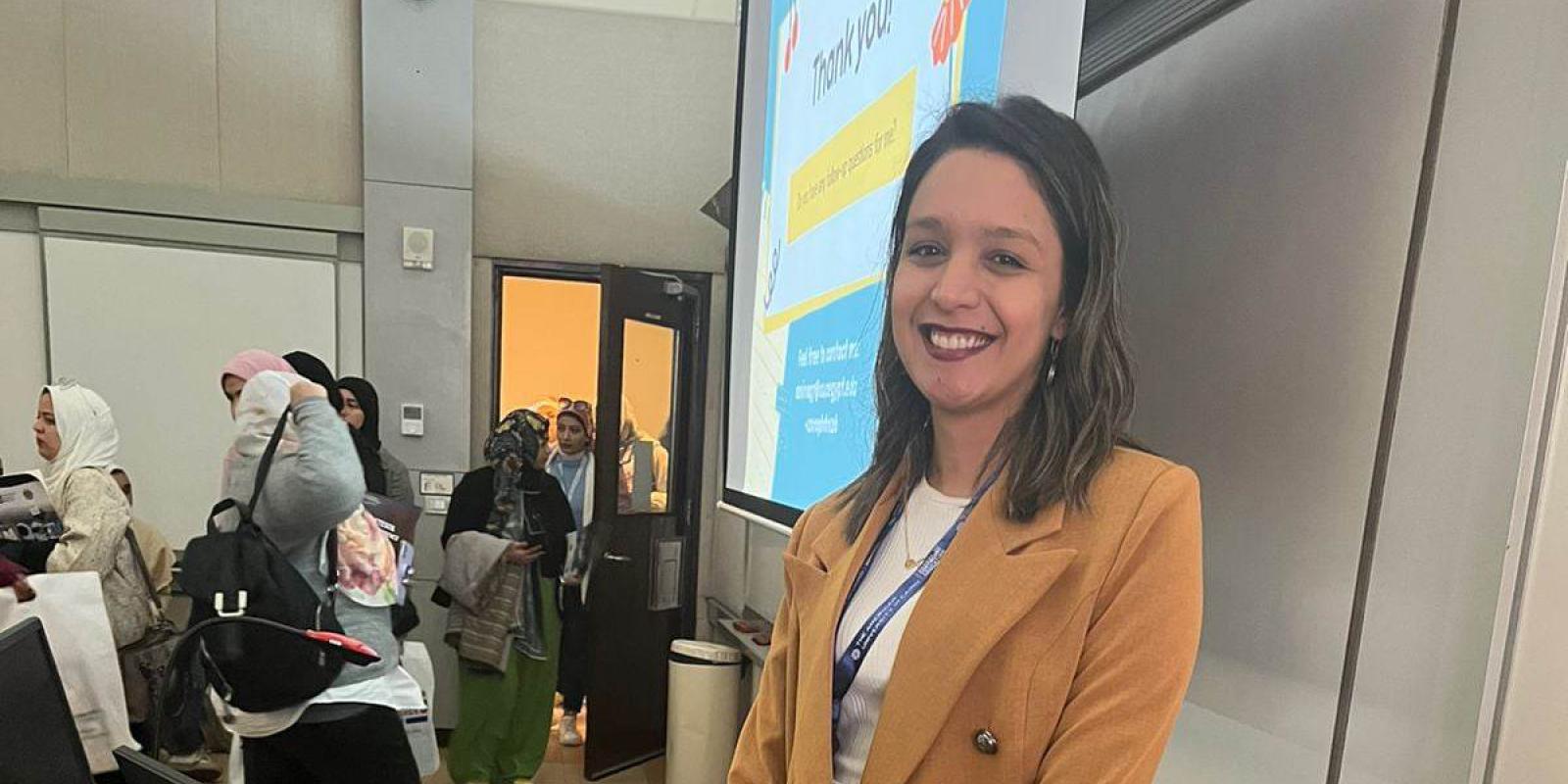 A smiling girl wearing a suit in classroom