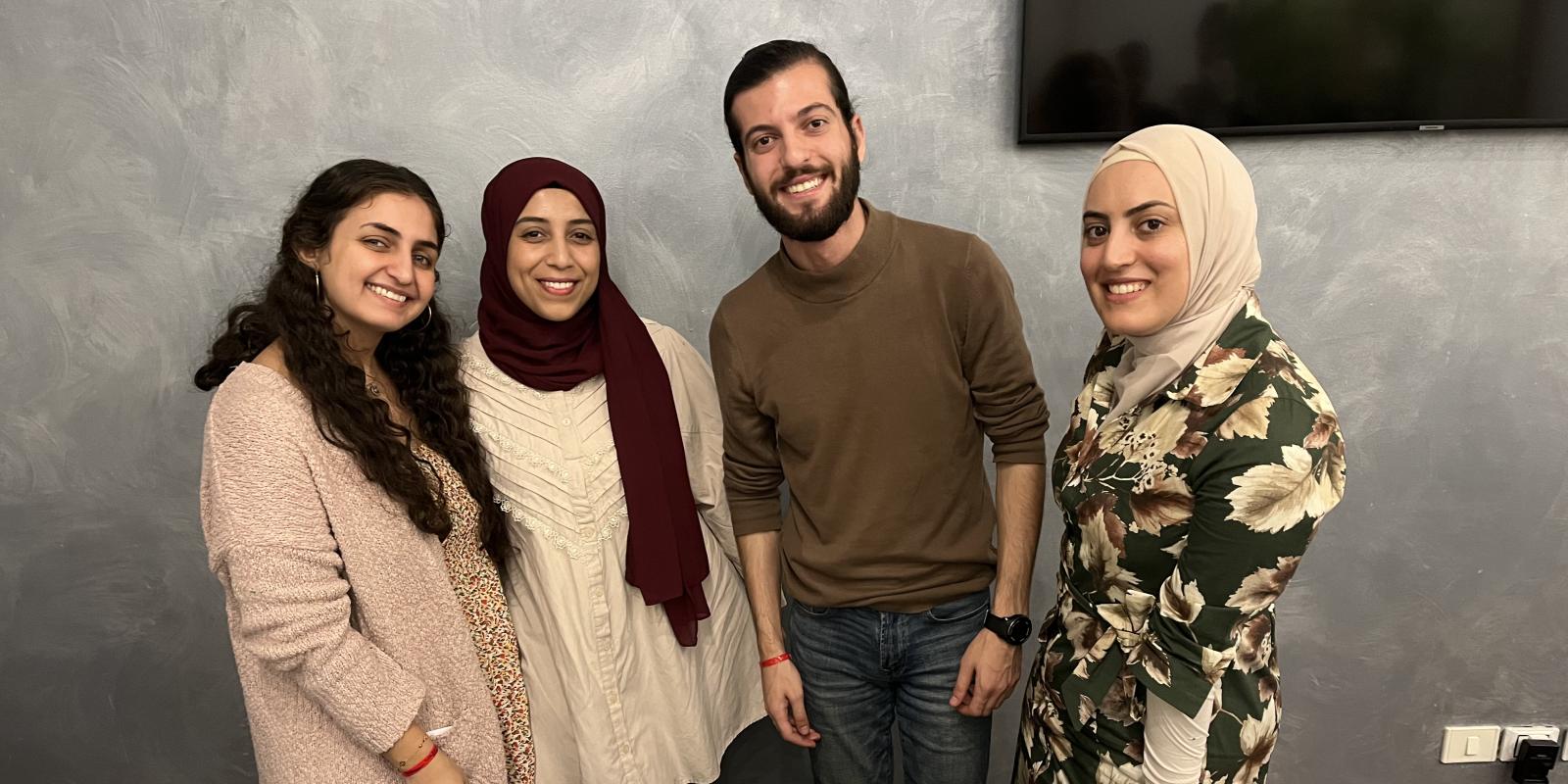 Girls and boy standing infront of their project
