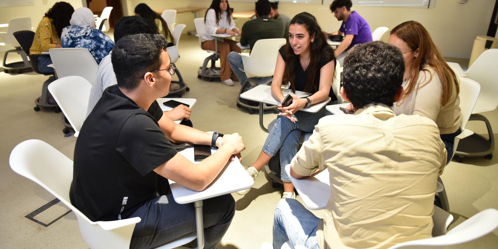 students working in a group in classroom having a group discussion